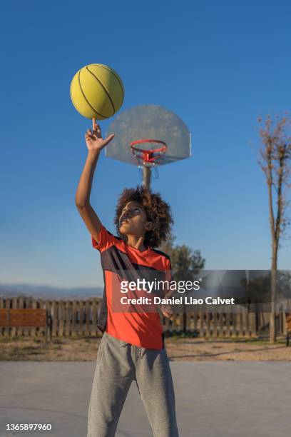 african american basketball player boy spinning ball on finger - drive ball sports stock pictures, royalty-free photos & images