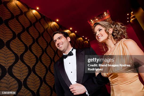 elegant hispanic couple walking together - tuxedo stock pictures, royalty-free photos & images