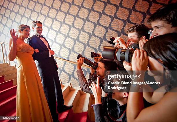 famous hispanic couple posing for press photographers - red carpet stairs stock pictures, royalty-free photos & images