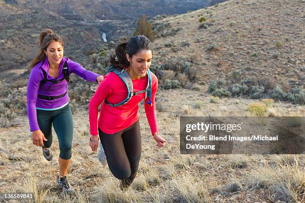 hispanic runners training in remote area - taos stock-fotos und bilder