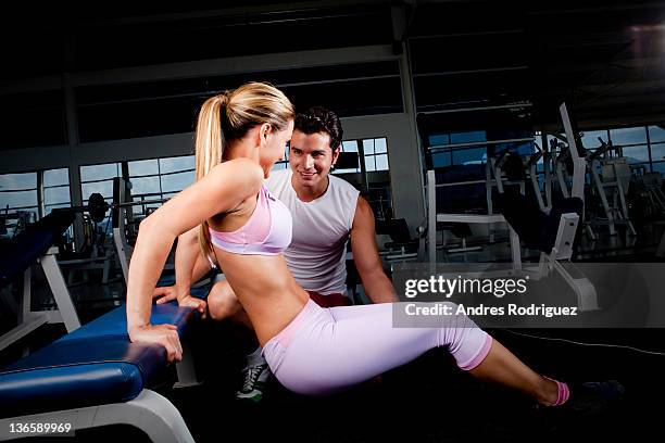 hispanic woman working with personal trainer in health club - cundinamarca bildbanksfoton och bilder