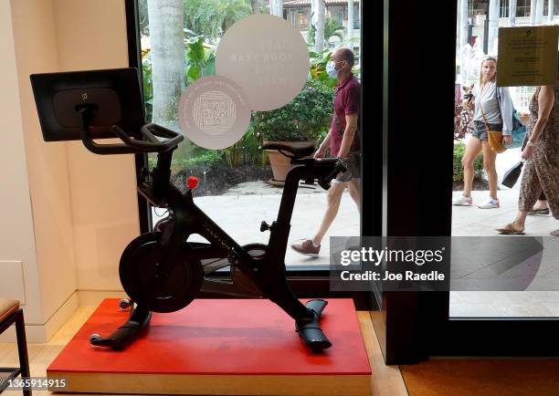 People walk past a Peloton store on January 20, 2022 in Coral Gables, Florida. Reports indicate that Peloton Interactive Inc is temporarily halting...