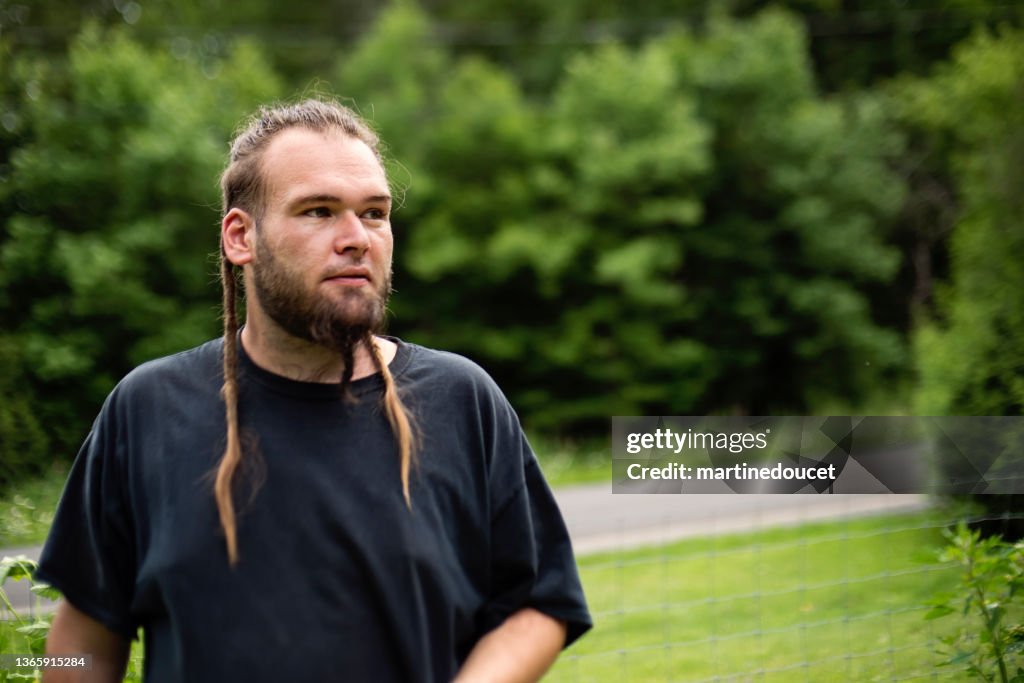 Portrait of young man with beard in nature.