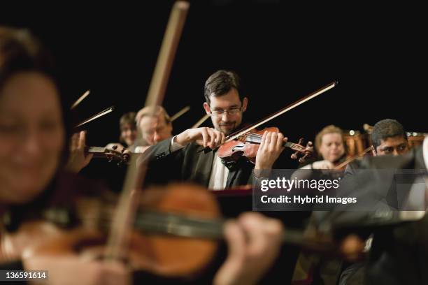 violin players in orchestra - musica clássica imagens e fotografias de stock