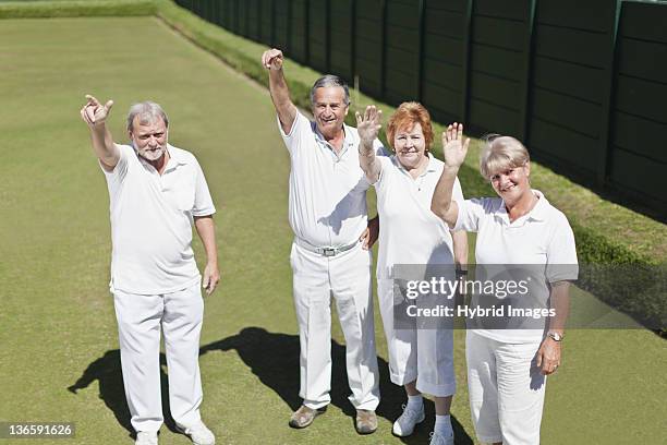 older people waving from lawn - bowling stock pictures, royalty-free photos & images