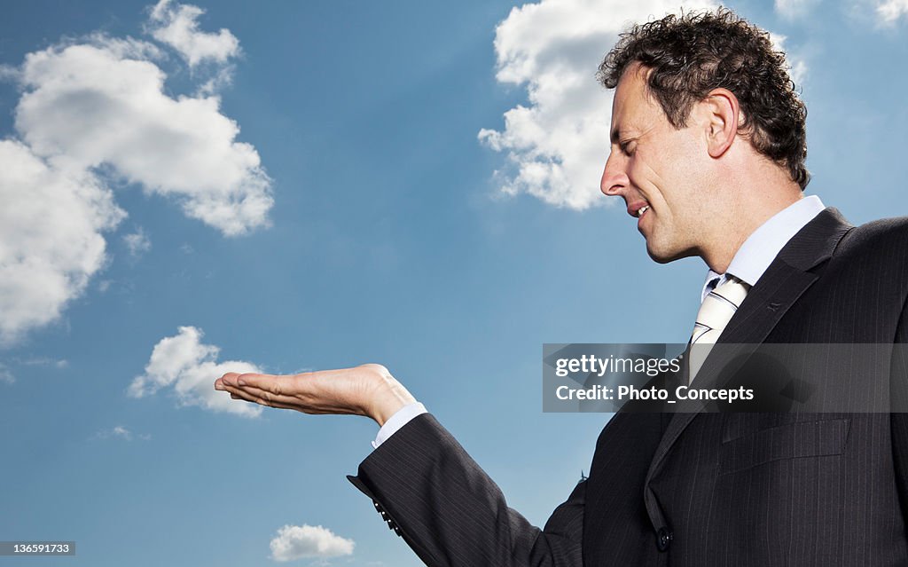 Businessman extending palm outdoors