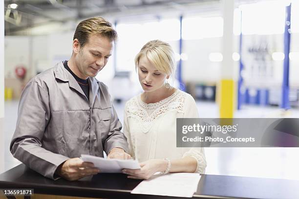 mechanic talking to customer in garage - car repair stock pictures, royalty-free photos & images