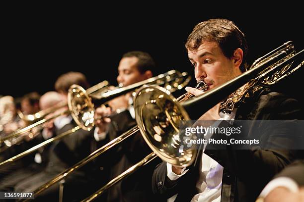 trumpet players in orchestra - classical music stock pictures, royalty-free photos & images