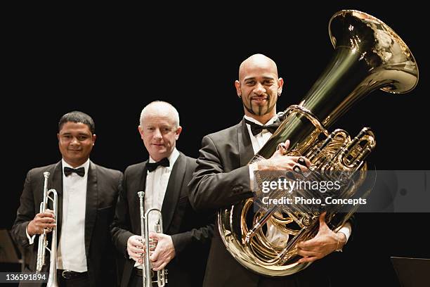 tuba player in orchestra - tube foto e immagini stock