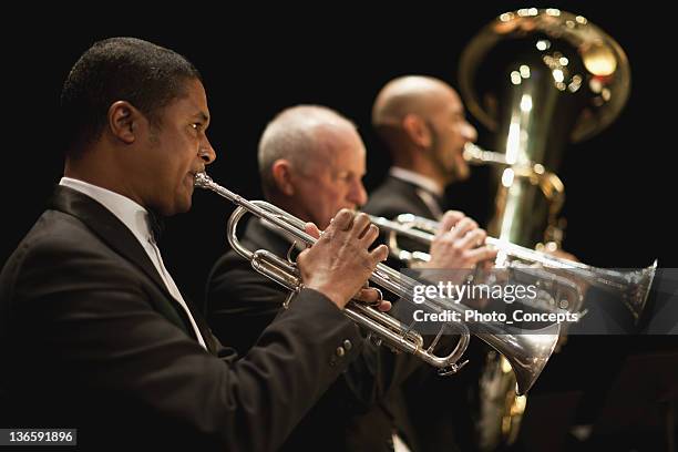 trumpet players in orchestra - blaasinstrument stockfoto's en -beelden