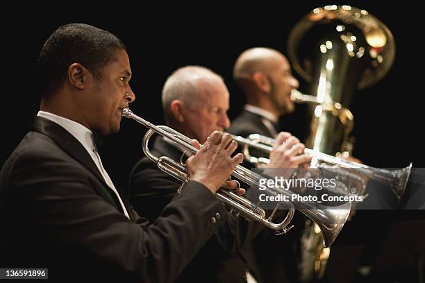 trumpet players in orchestra - orchestra stock pictures, royalty-free photos & images