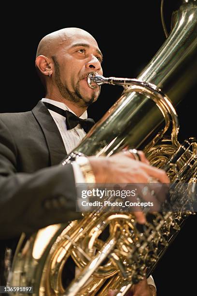 tuba player in orchestra - tuba stock pictures, royalty-free photos & images