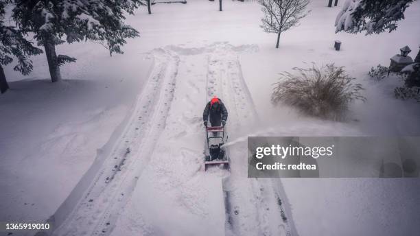 man using snowblower in deep snow - plowing stock pictures, royalty-free photos & images