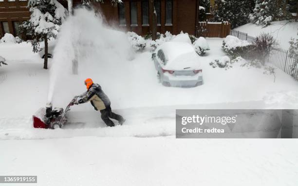 man using snowblower in deep snow - snow vehicle stock pictures, royalty-free photos & images