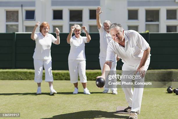 older people playing lawn bowling - lawn bowling stock pictures, royalty-free photos & images