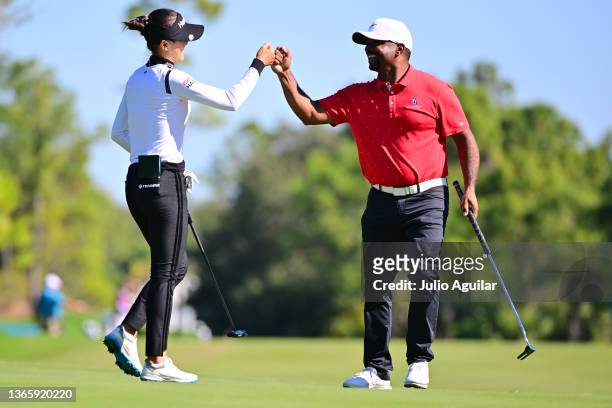 Lydia Ko of New Zealand celebrates with Alfonso Ribeiro after a putt on the eighth green during the first round of the 2022 Hilton Grand Vacations...