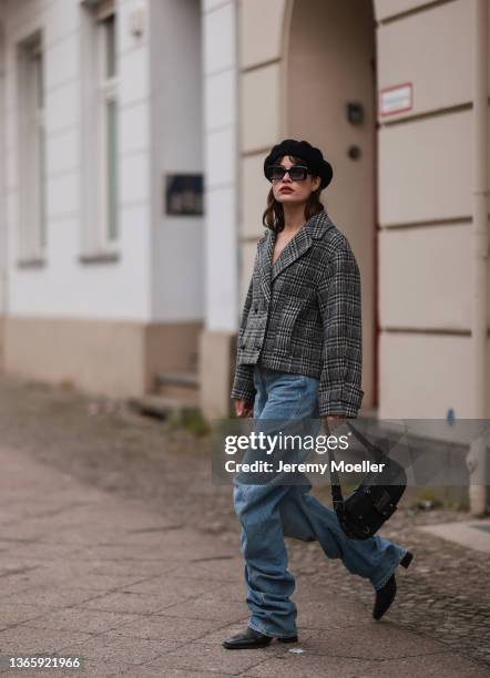 Lea Naumann wearing black beret, black Gigi Studios shades, black and white Baum & Pferdgarten jacket, blue Weekday jeans, black vintage Dior leather...