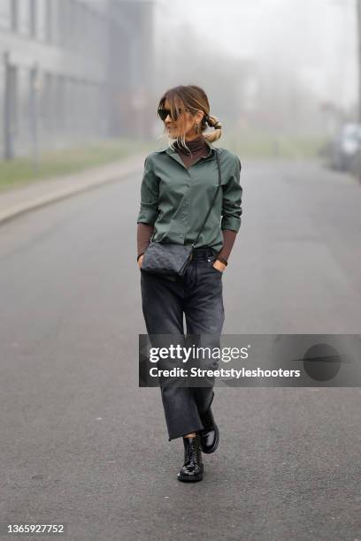 Influencer Gitta Banko wearing a brown turtleneck pullover by Intimissimi, an olive green blouse by Steffen Schraut, dark grey denim jeans pants by...