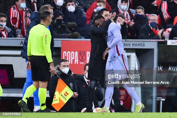 Head coach Xavi Hernandez of FC Barcelona comforts Ansu Fati of FC Barcelona as he walks off the pitch with an injury during the Copa Del Rey round...