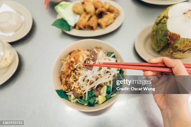 personal perspective of young woman eating vietnamese noodle salad at the restaurant - coconut water stock pictures, royalty-free photos & images