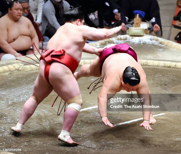 Onosho throws Sekiwake Mitakeumi to win on day twelve of the Grand Sumo New Year Tournament at Ryogoku Kokugikan on January 20, 2022 in Tokyo, Japan.