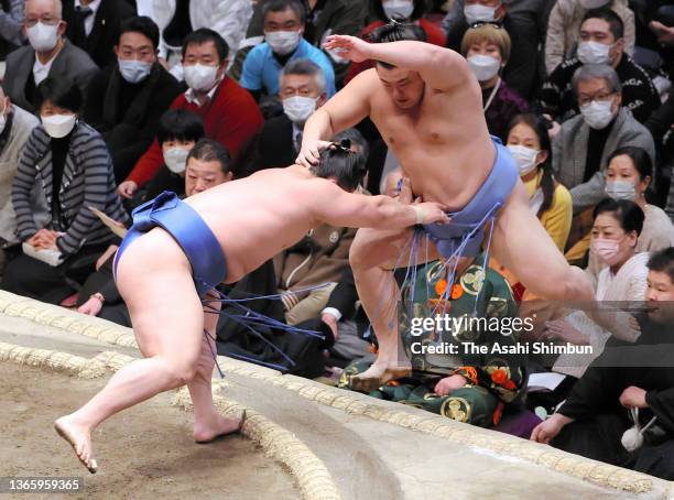 Wakatakakage pushes Tobizaru out of the ring to win on day twelve of the Grand Sumo New Year Tournament at Ryogoku Kokugikan on January 20, 2022 in...