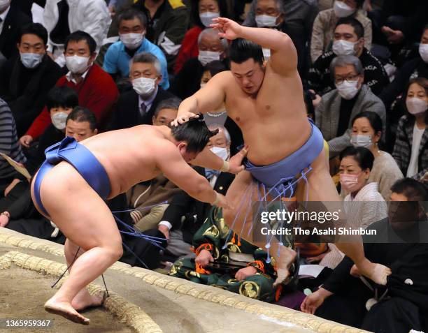 Wakatakakage pushes Tobizaru out of the ring to win on day twelve of the Grand Sumo New Year Tournament at Ryogoku Kokugikan on January 20, 2022 in...