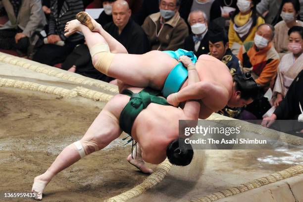 Kotonowaka throws Sadanoumi to win on day twelve of the Grand Sumo New Year Tournament at Ryogoku Kokugikan on January 20, 2022 in Tokyo, Japan.