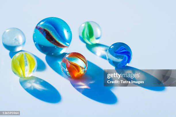 studio shot of colorful marbles - knikkers stockfoto's en -beelden