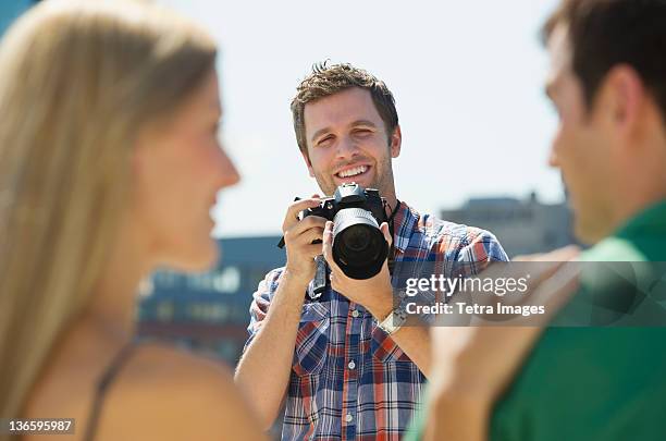 usa, new jersey, jersey city, photographer taking picture of couple - professional photo shoot stock pictures, royalty-free photos & images