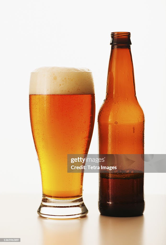 Studio shot of bitter ale in bottle and glass