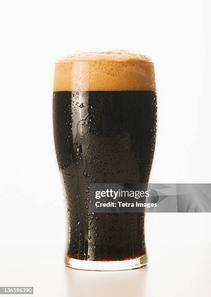 studio shot of dark beer in glass - real ale stock-fotos und bilder