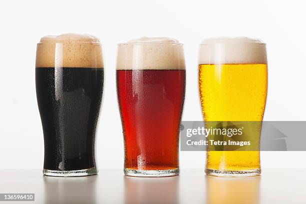 three beers in glasses, studio shot - cerveja amarga imagens e fotografias de stock