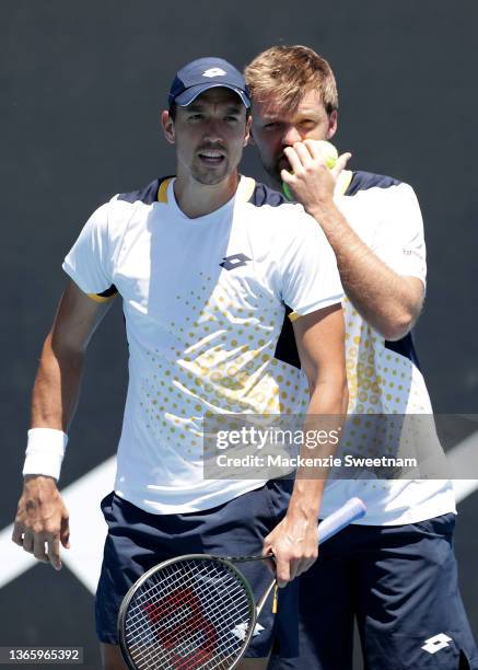 Andreas Mies and Kevin Krawietz of Germany talk tactics in their second round doubles match against Sam Querrey and Austin Krajicek of United States...