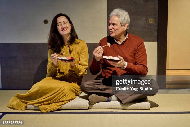 couple enjoys traditional japanese sweets in japanese style during a travel visit to kyoto. - tea ceremony stock-fotos und bilder