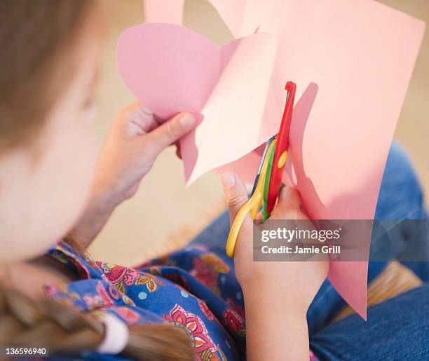 usa, new jersey, jersey city, girl ( 6-7) cutting heart shape for valentine's day - child cutting card stock pictures, royalty-free photos & images