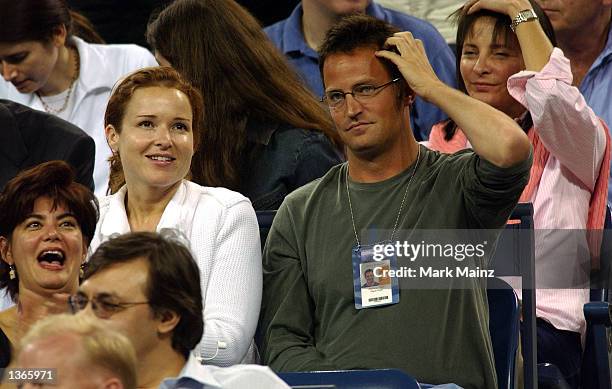 Actor Matthew Perry with an unidentified companion watches Pete Sampras play a match at the 2002 U.S. Open on September 3, 2002 in Flushing, New York.