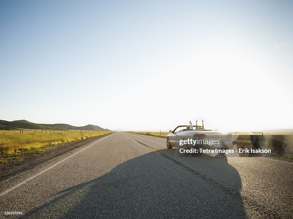 USA, Utah, Kanosh, Happy couple driving on empty road