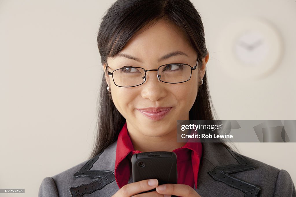 Studio portrait of businesswoman text-messaging