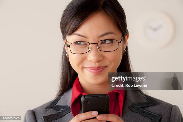 studio portrait of businesswoman text-messaging - smug stock pictures, royalty-free photos & images