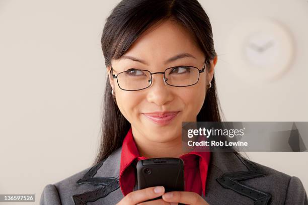 studio portrait of businesswoman text-messaging - smug 個照片及圖片檔