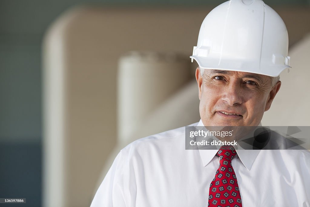 USA, New Mexico, Santa Fe, Portrait of senior man wearing tie and hardhat