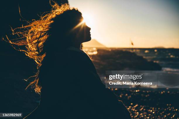 happy young woman traveler raises hands against stunning view of stormy mediterranean sea - air crash investigation stock pictures, royalty-free photos & images