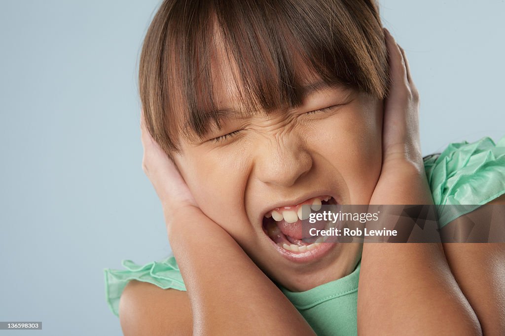 Studio shot of girl (10-11) shouting