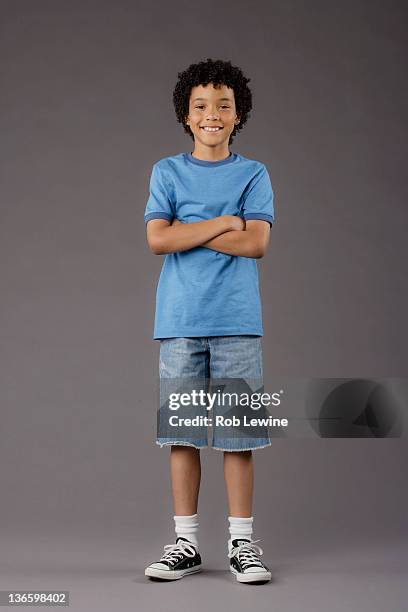 portrait of smiling boy (8-9), studio shot - short shorts stock pictures, royalty-free photos & images