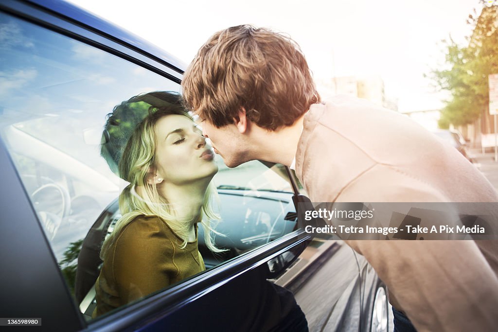 USA, Washington, Seattle, Young couple kissing through window of car