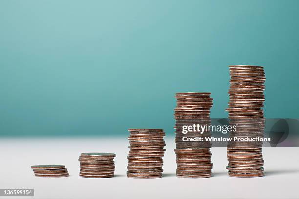 studio shot of stacks of coins - coin stack stock pictures, royalty-free photos & images
