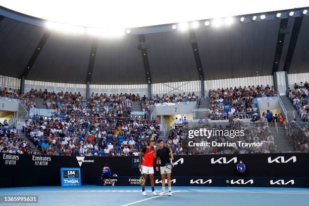 Nick Kyrgios of Australia and Thanasi Kokkinakis of Australia talk tactics in their second round doubles match against Nikola Mektic of Croatia and...