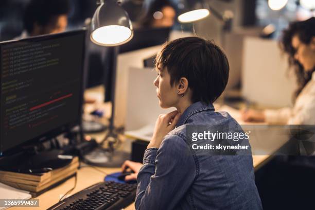 female computer programmer working on desktop pc in the office. - female programmer stock pictures, royalty-free photos & images