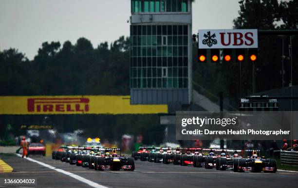 Pirelli and UBS advertising hoarding billboards displayed behind and above the Pole position starting German Red Bull Racing Formula One team racing...